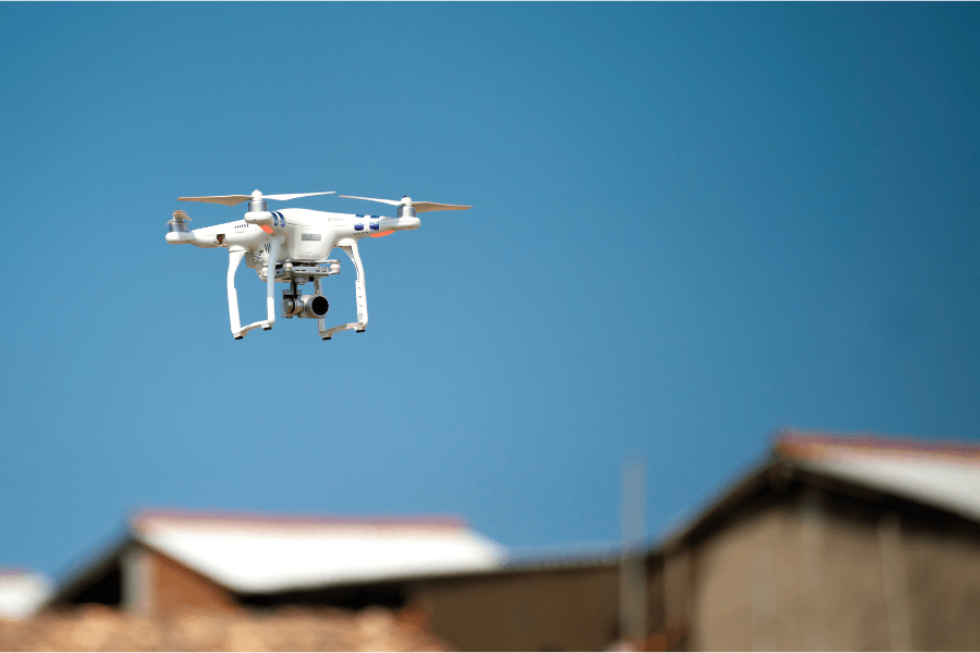 Drone Roof Inspections. Drone flying over row of roof tops