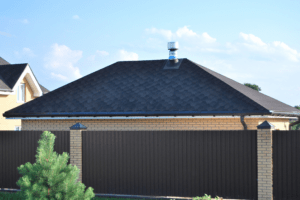 material for garage roofs , showing a hip style roof with a vent and gutters.